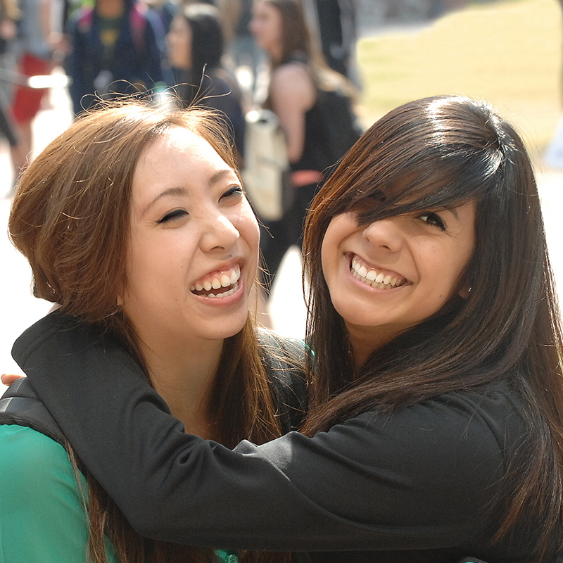 Close up of two female friends hugging