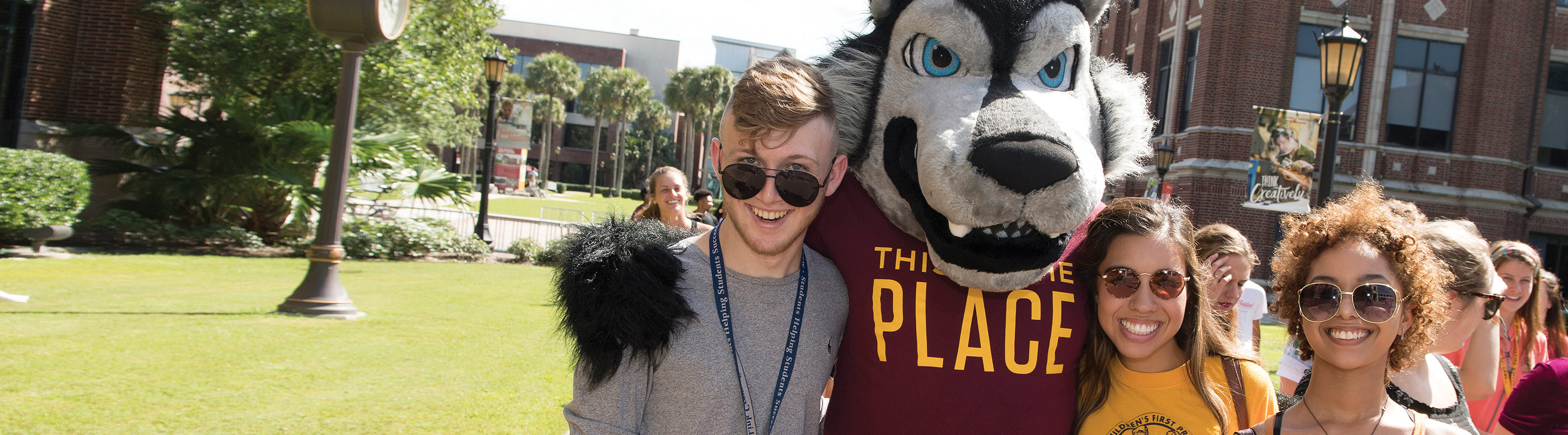 Students hugging Havoc mascot
