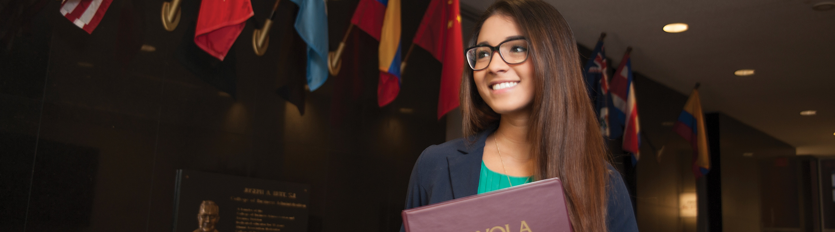 Student with portfolio among international flags