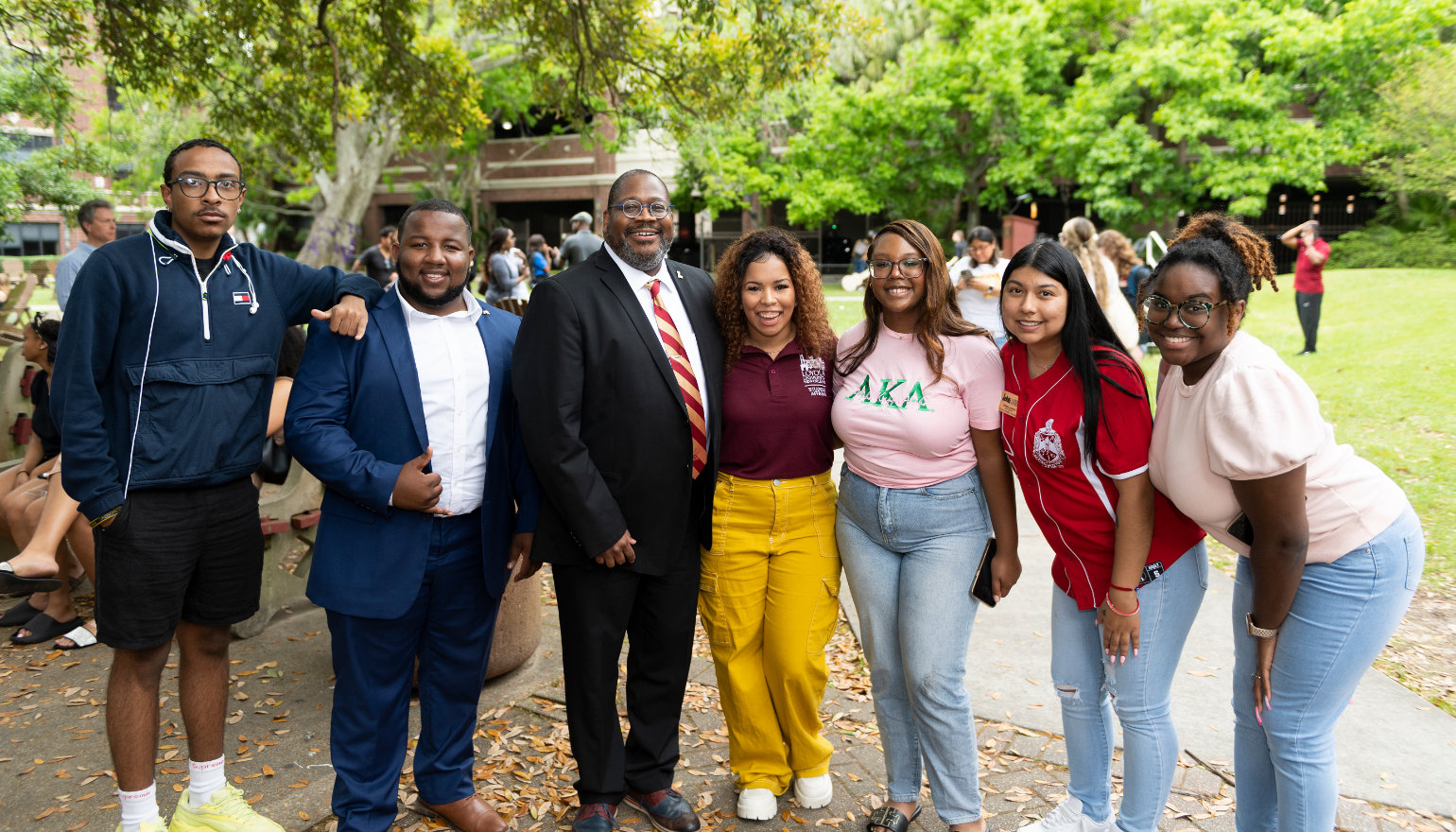 Dr. Cole poses with students and staff at the welcome event.
