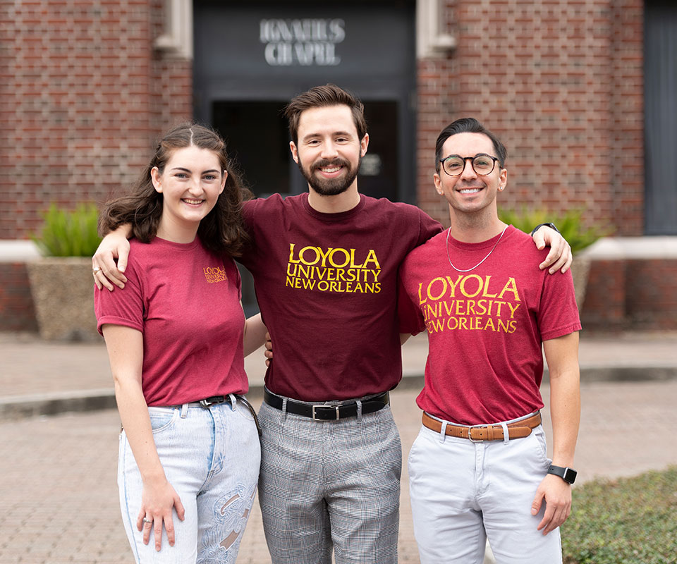 Three Loyola Students Wearing Maroon and Gold