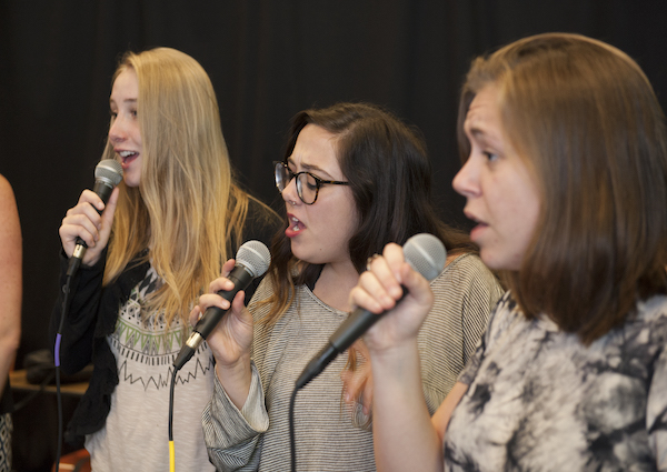 Vocalists rehearsing with microphones